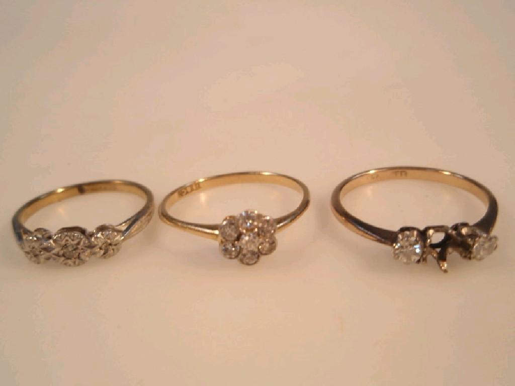 Appraisal: Three diamond set rings one flower head cluster stamped ct