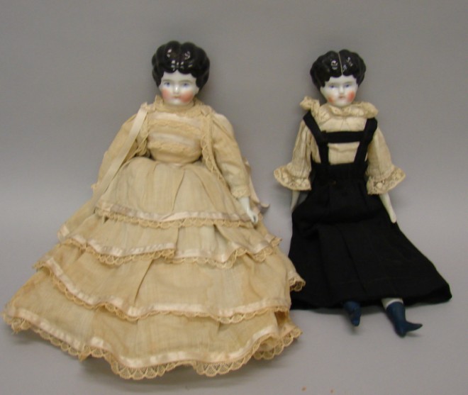 Appraisal: Pair of china Lowbrows with black hair and molded heeled