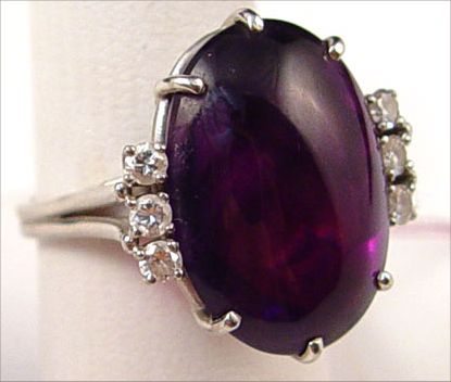 Appraisal: PLATINUM AMETHYST DIAMOND RING Ct oval cabochon amethyst accented with