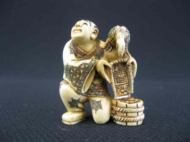 Appraisal: Carved Ivory Netsuke man with bird bucket polychromed signed ''