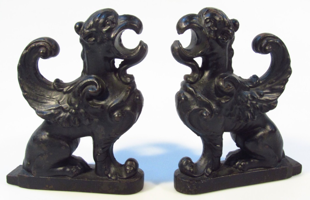 Appraisal: A pair of thC cast iron griffin doorstops each heavily