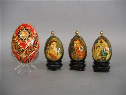 Appraisal: Four Russian lacquered eggs th century Comprising an egg painted