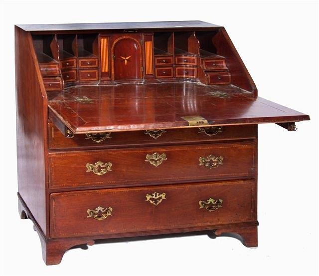 Appraisal: A GEORGE III MAHOGANY BUREAU the interior fitted central cupboard