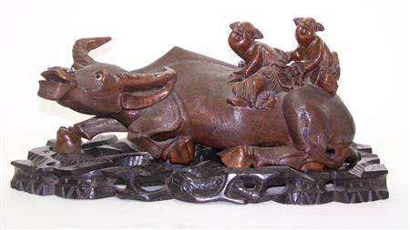 Appraisal: A Chinese carved hardwood buffalo with inset eyes in a