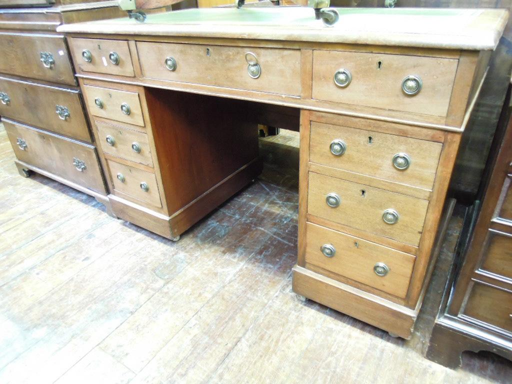 Appraisal: A th century mahogany kneehole pedestal desk with inset leather