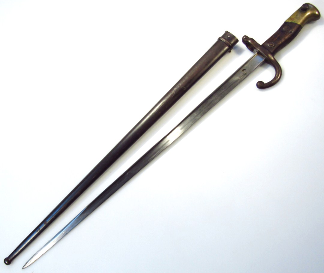 Appraisal: A thC Parisian bayonet and scabbard the plain steel blade