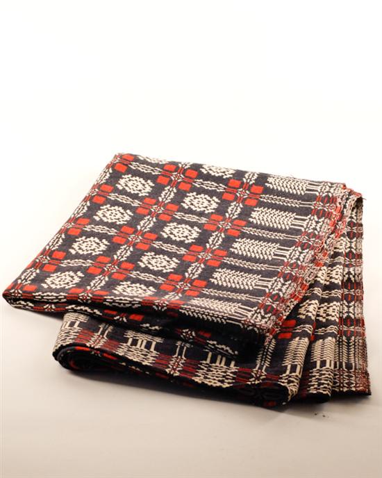 Appraisal: A Red White and Blue Jacquard Woven Coverlet with a