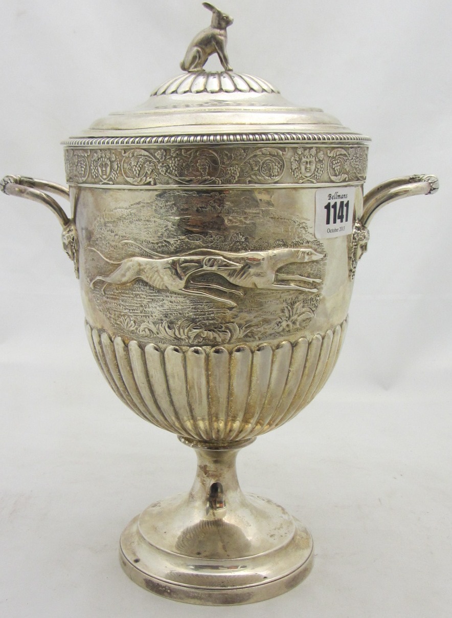 Appraisal: A silver twin handled lidded trophy goblet the body with