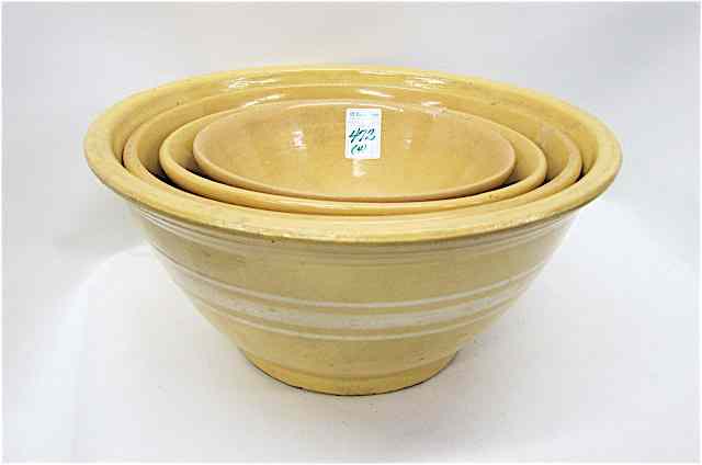 Appraisal: FOUR YELLOWWARE STONEWARE POTTERY MIXING BOWLS three with orange brown