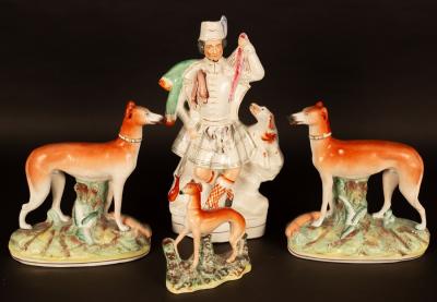 Appraisal: A pair of Staffordshire greyhounds on oval bases cm high