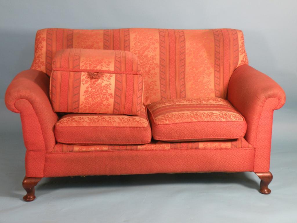 Appraisal: An Edwardian mahogany drop-arm sofa two matching wing armchairs and