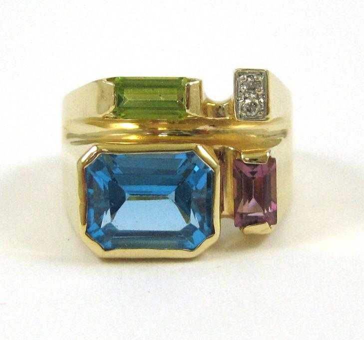 Appraisal: BLUE TOPAZ PERIDOT AND AMETHYST RING The k yellow gold