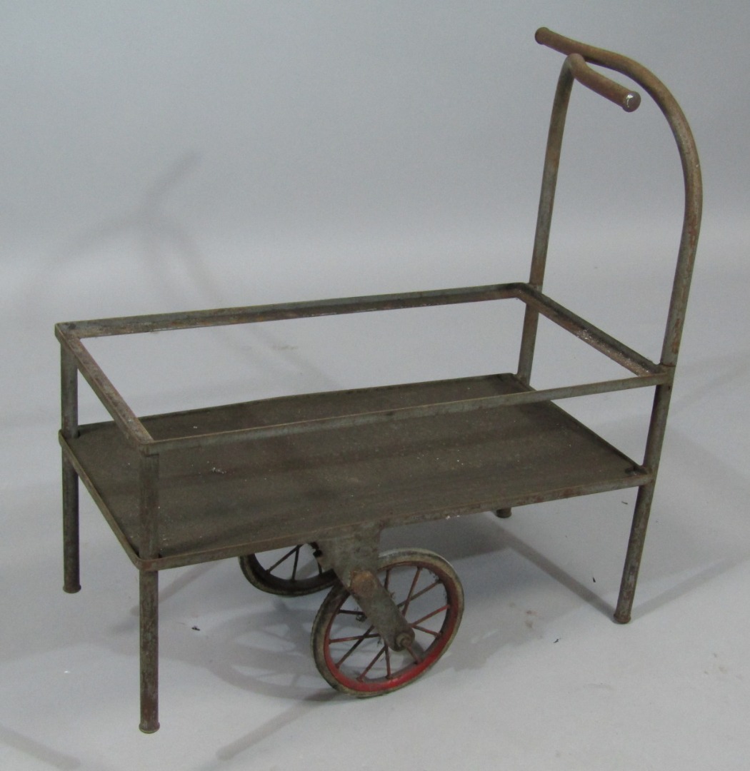 Appraisal: An early thC metal framed cart with central spoked wheel