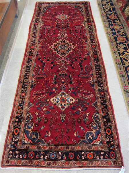 Appraisal: PERSIAN HAMADAN TRIBAL HALL CARPET featuring three diamond-shaped floral medallions