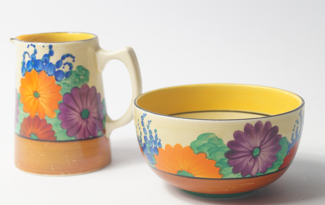 Appraisal: A Clarice Cliff Bizarre cream jug and sugar bowl decorated