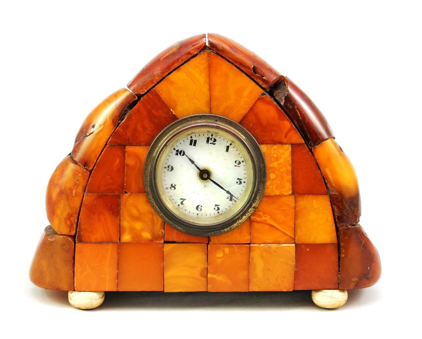 Appraisal: A reconstituted amber mounted mantel clock of arch top form