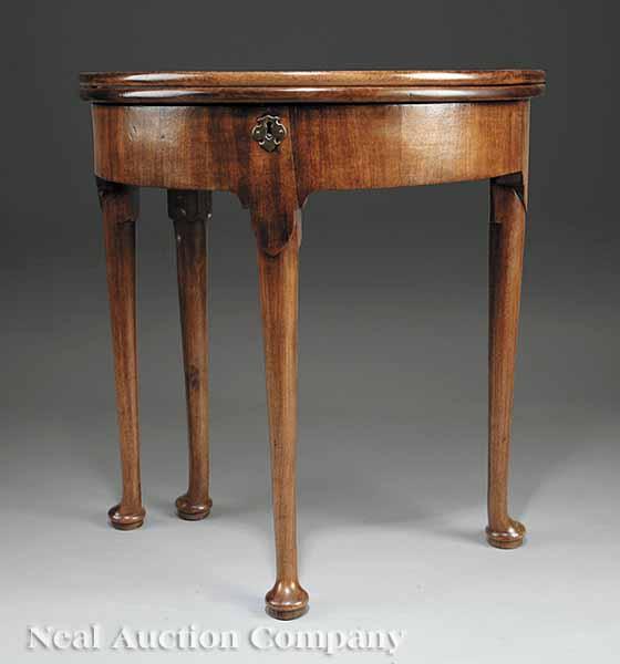 Appraisal: An Antique George II-Style Mahogany Tea Table demilune foldover top