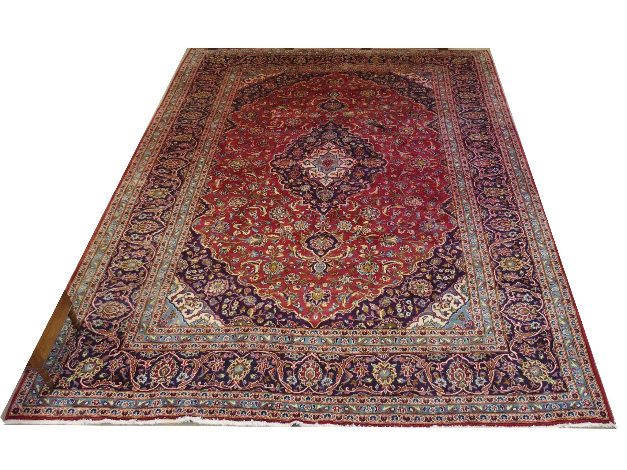 Appraisal: A Persian carpetthe red ground with central foliate medallion within