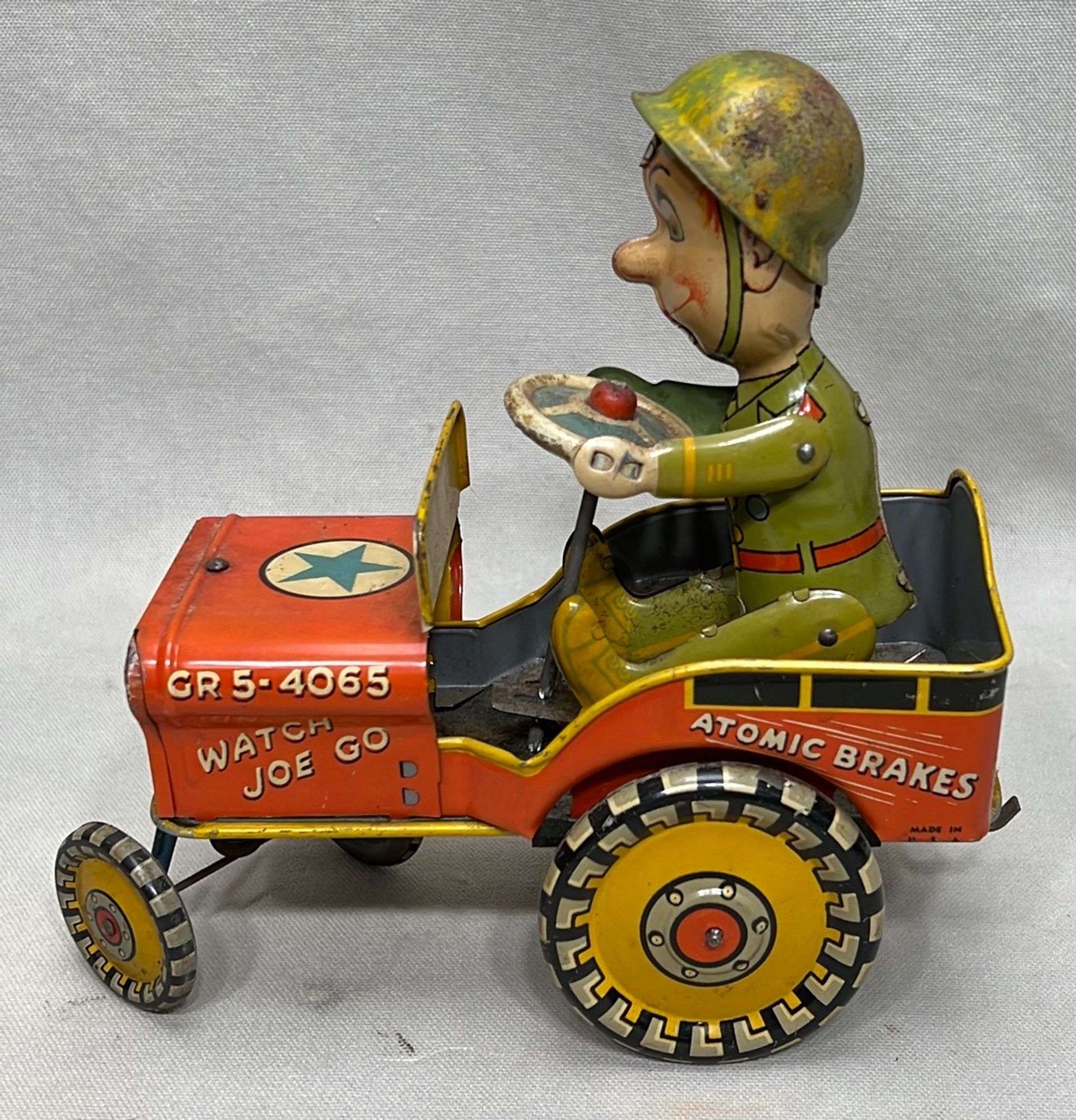 Appraisal: Unique Art GI Joe Jouncing Jeep tin wind-up toy