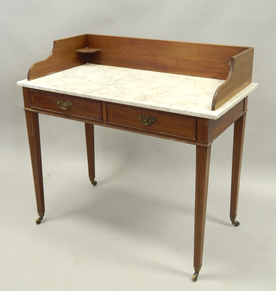 Appraisal: An Edwardian mahogany wash stand with a raised back and