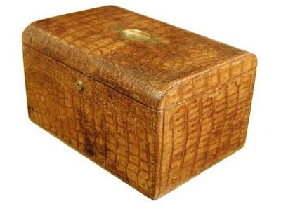 Appraisal: A crocodile jewellery case with engraved brass sunken handle to