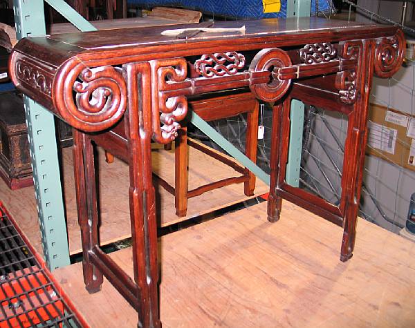 Appraisal: A mixed wood side table Its top with floating panel