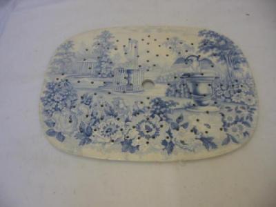 Appraisal: AN ENGLISH POTTERY MEAT STRAINER blue printed with a fountain