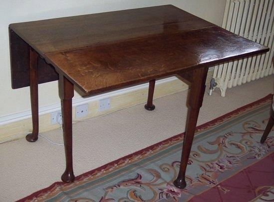 Appraisal: A George II oak drop leaf table with rectangular hinged