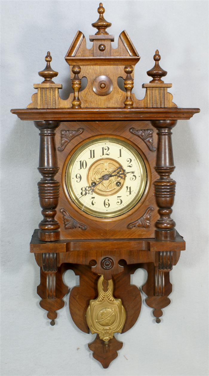 Appraisal: Carved walnut German wall clock day double spring driven movement