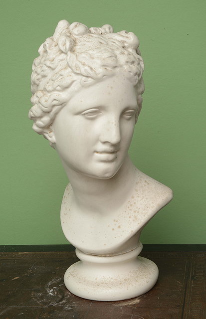 Appraisal: A PAINTED PLASTER BUST of a young girl after the