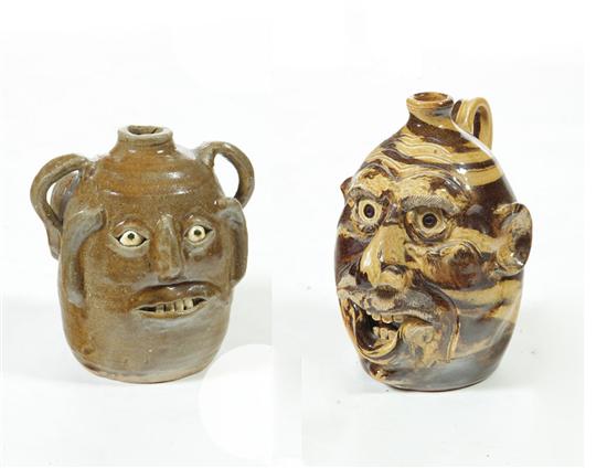 Appraisal: TWO GROTESQUE JUGS American late th century Double faced inscribed