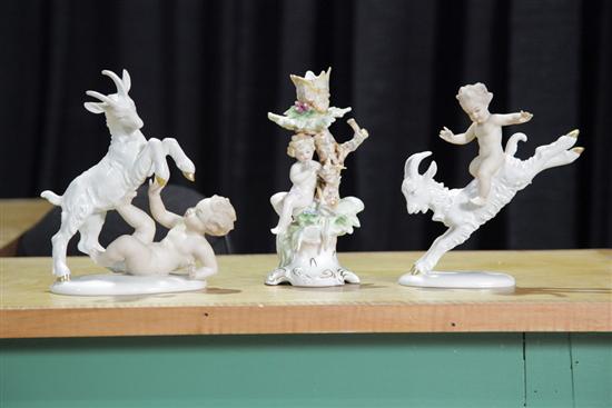 Appraisal: THREE PORCELAIN FIGURES Pair with cherubs and goats Marked ''Germany''