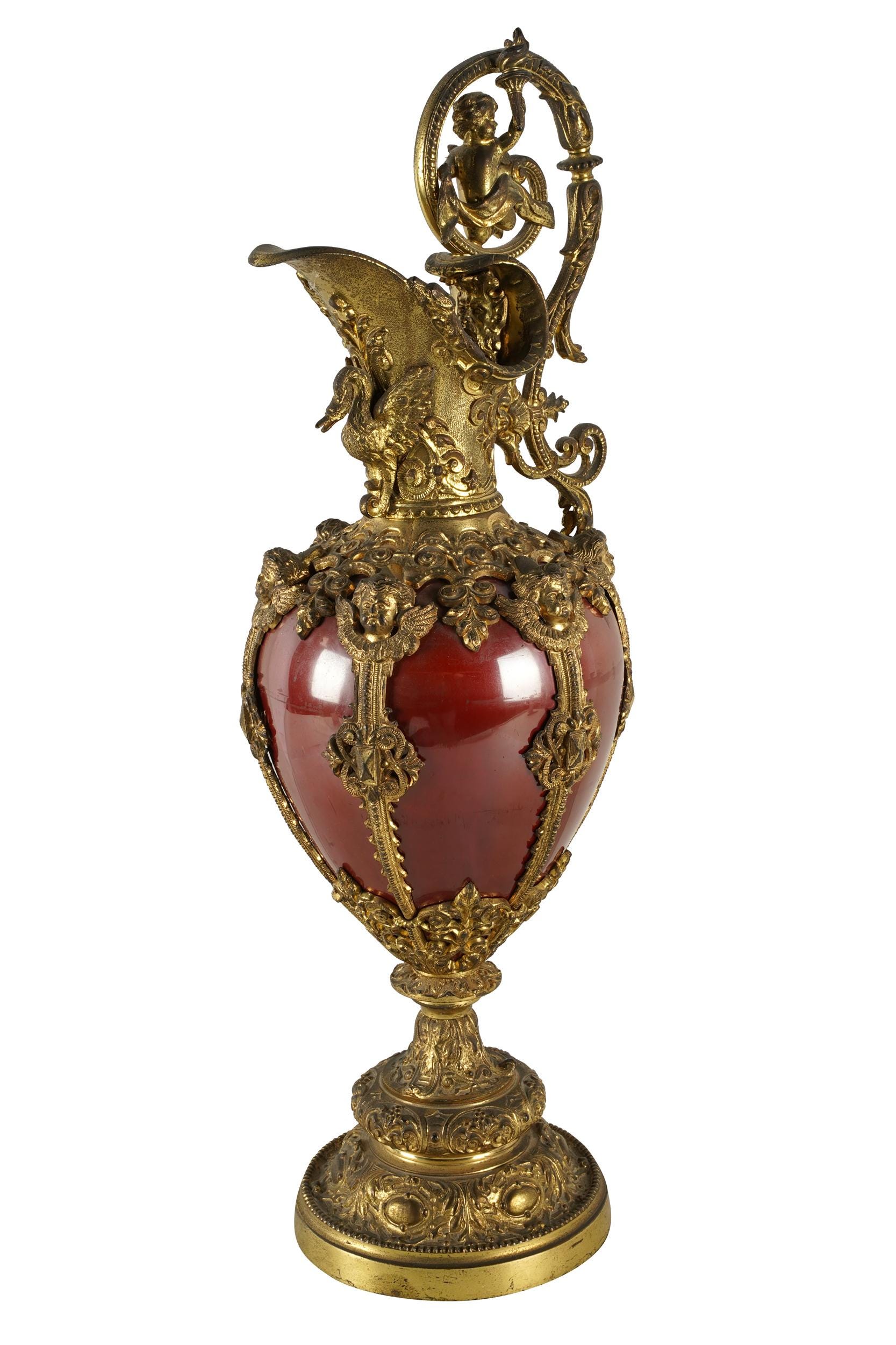 Appraisal: CONTINENTAL GILT RED-ENAMELED METAL EWER unmarked Condition darkening to gilding