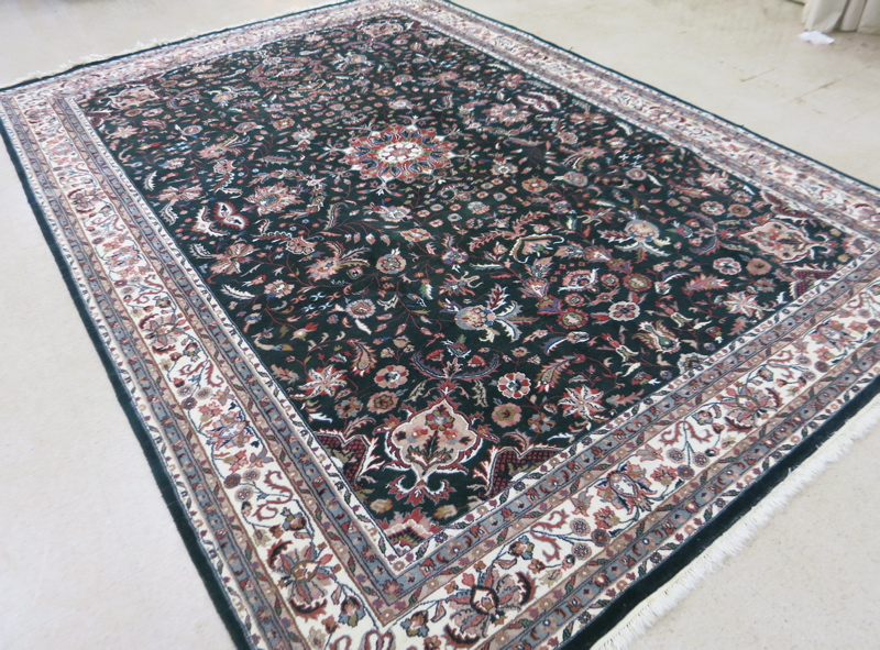 Appraisal: HAND KNOTTED ORIENTAL CARPET Indo-Persian overall floral design on hunter