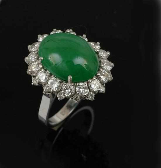 Appraisal: A jade and diamond cluster ring Centrally set with an