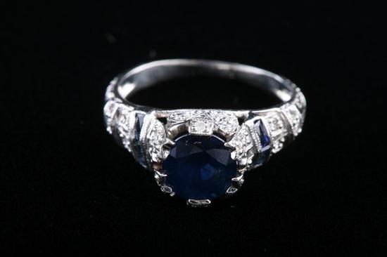 Appraisal: PLATINUM DIAMOND AND SAPPHIRE RING Circa Round sapphire weighing approximately