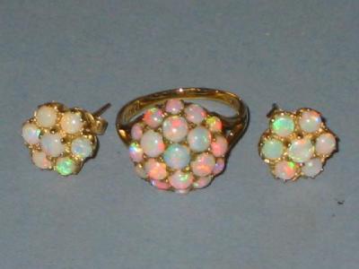 Appraisal: AN OPAL CLUSTER RING the domed top set with round