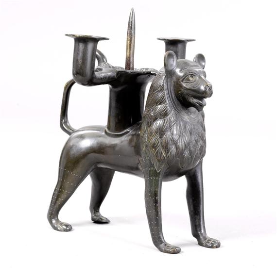 Appraisal: LION SCULPTURE AS CANDLEHOLDER in Romanesque style Bronze Three-branched candlestick