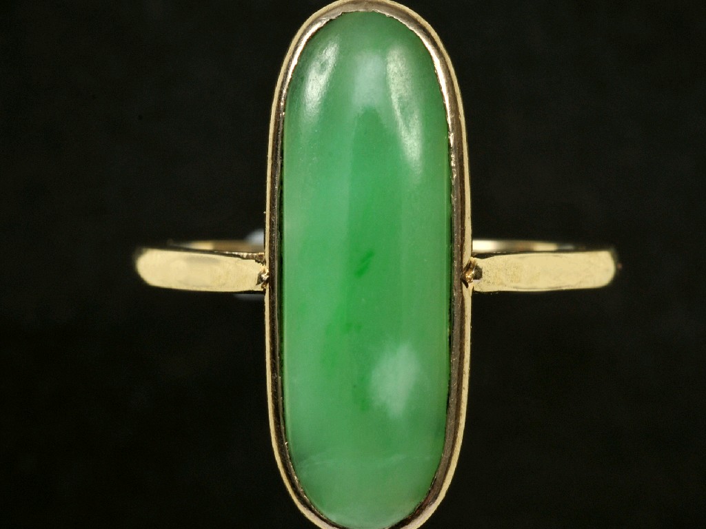 Appraisal: A Jade cabochon Ring the oval stone rub-over set in