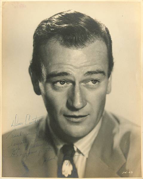 Appraisal: A John Wayne signed black and white photograph A vintage