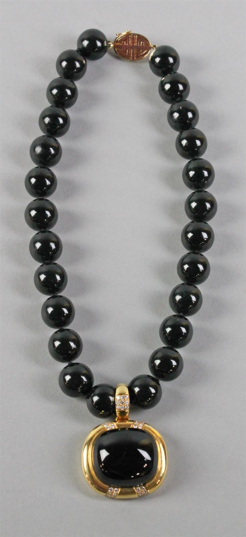 Appraisal: GUMP'S BLACK JADE AND K YELLOW GOLD NECKLACE consisting of