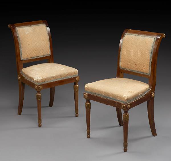 Appraisal: A pair of Empire style parcel gilt mahogany chairs first