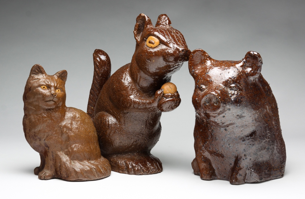 Appraisal: THREE AMERICAN SEWERTILE SEATED ANIMALS Late th-early th century Pig