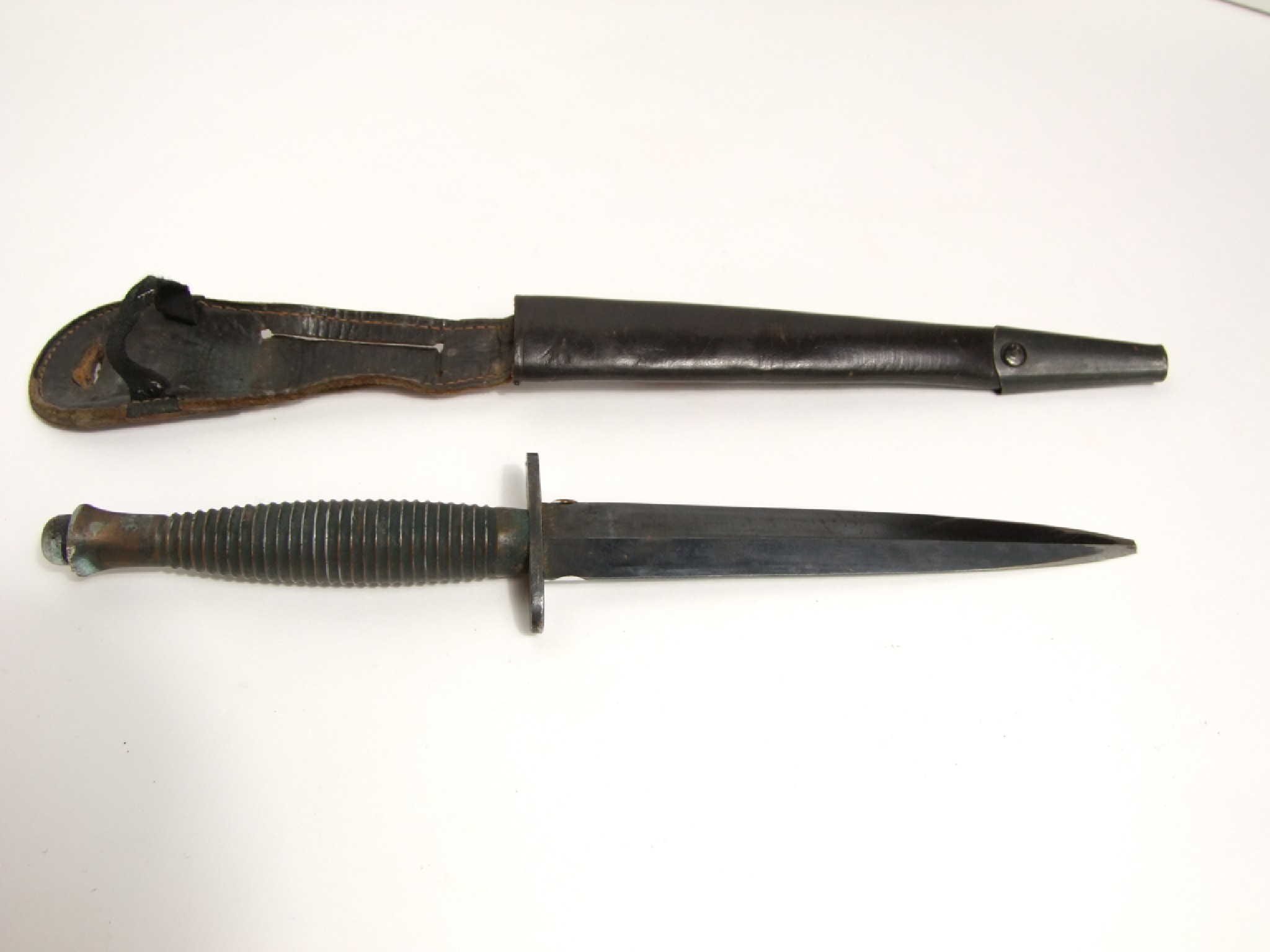 Appraisal: A dagger with cm blade turned brass grip and leather