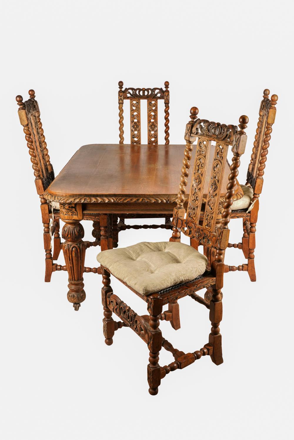 Appraisal: CARVED OAK TABLE FOUR CHAIRSchairs with studded leather upholstered seats