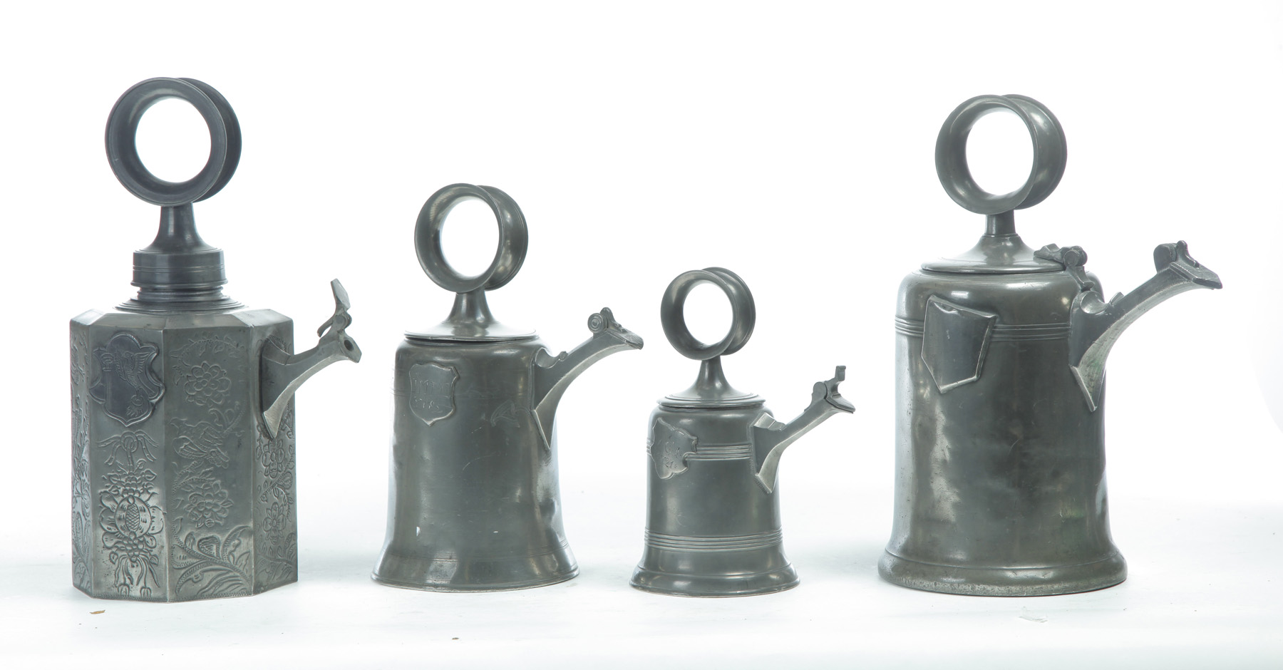 Appraisal: FOUR SWISS PEWTER WINE FLAGONS Eighteenth- th century Similar with