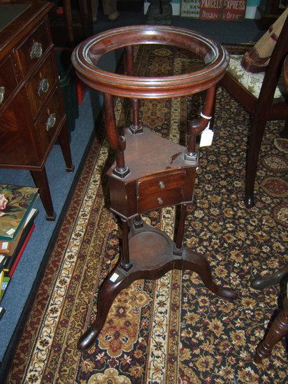 Appraisal: An th Century mahogany basin or wig stand of triangular