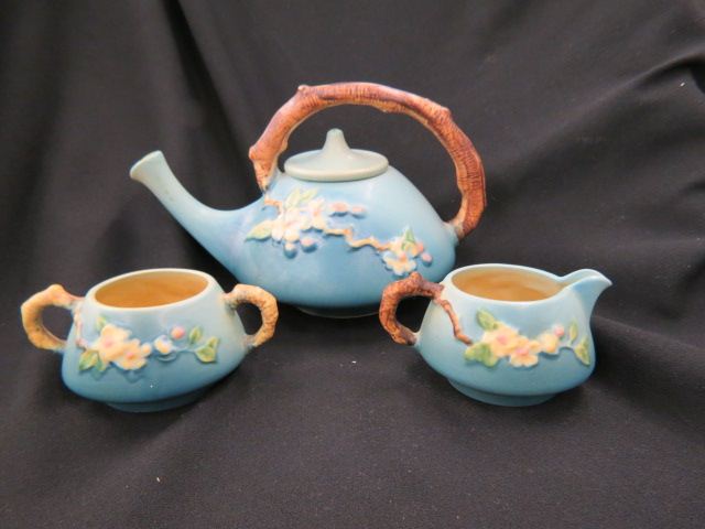 Appraisal: Roseville Pottery Apple Blossom Tea Set blue teapot is tall