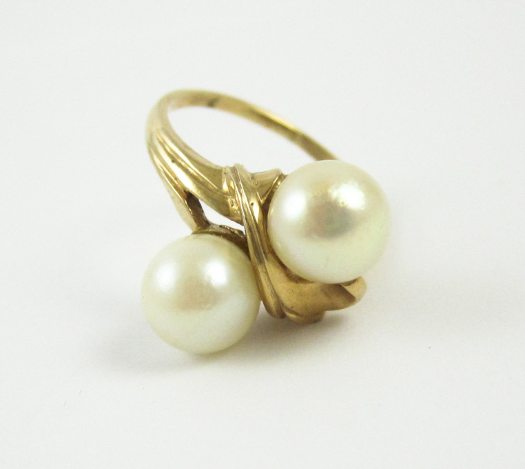 Appraisal: PEARL AND FOURTEEN KARAT GOLD RING set with two round