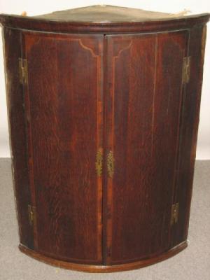 Appraisal: A GEORGE III OAK CORNER CUPBOARD th century of quadrant